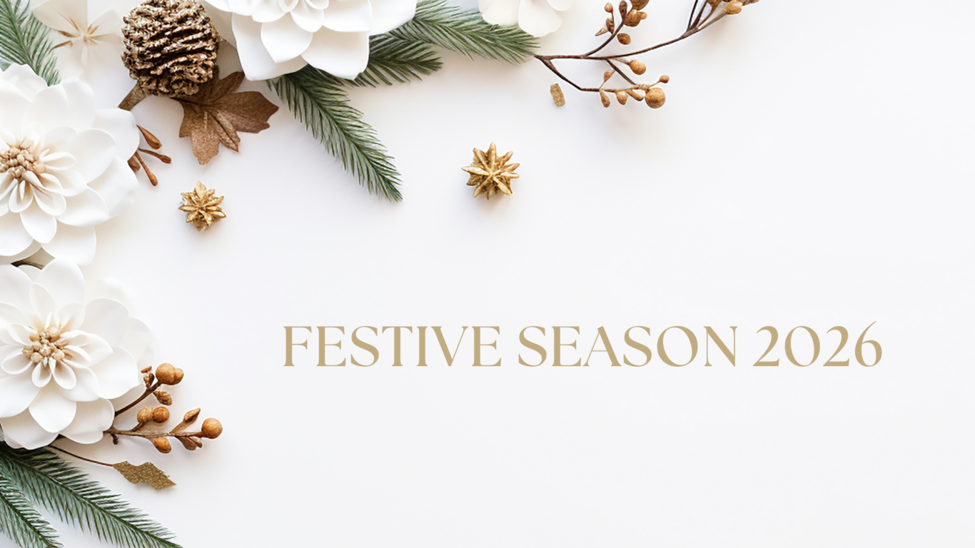 Elegant festive decor with white flowers and pinecones, inviting you to a luxurious 2026 holiday at the Glenview Hotel.