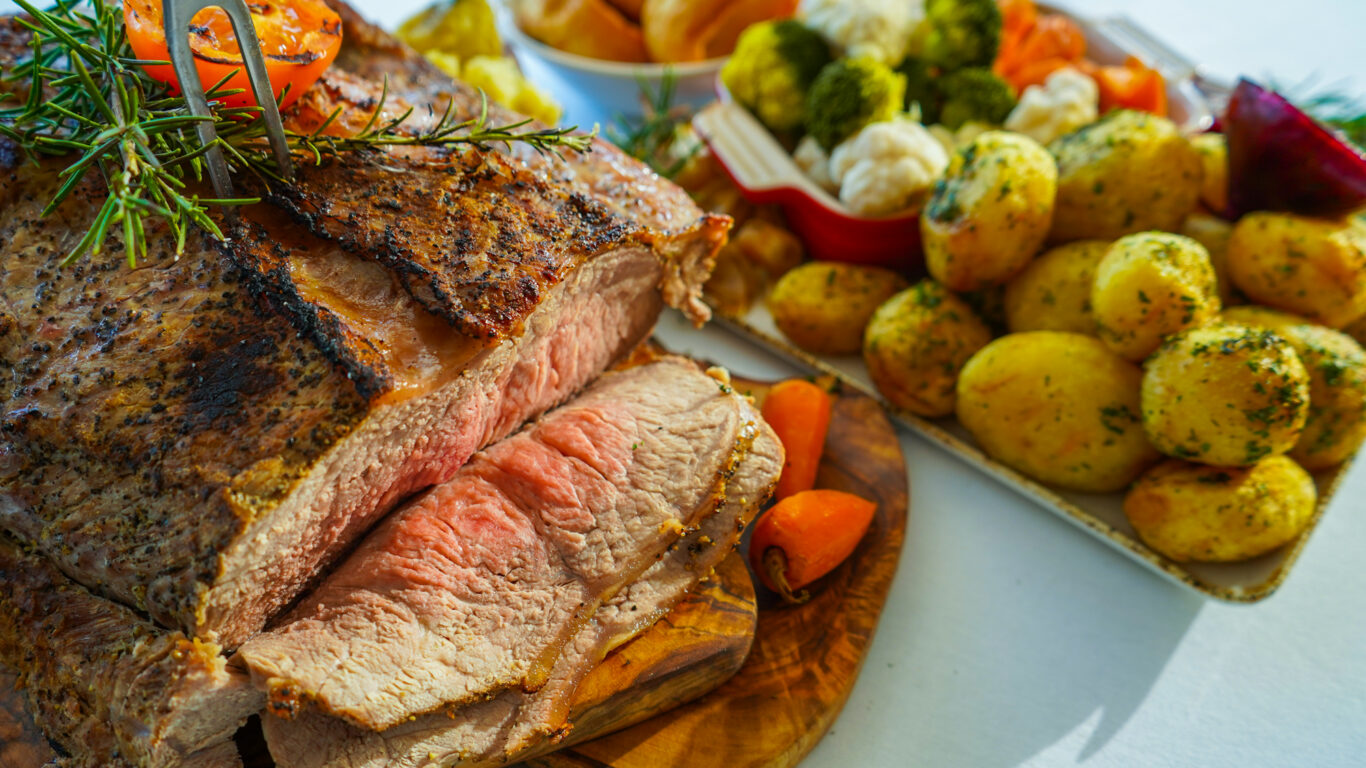 Savour succulent roast beef with herbs, and a side of golden potatoes and fresh vegetables at our hotel restaurant.
